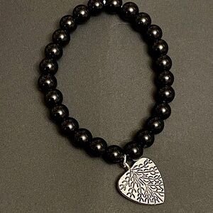 Black Round Onyx Beaded Bracelet With Silver Shaped Heart and Expressive Vanes.